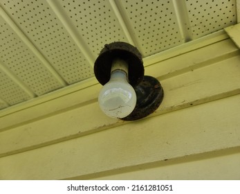 An Outside Light Fixture On The Side Of A Wall With No Cover On It. 