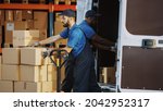 Outside of Logistics Distributions Warehouse: Diverse Team of Two Workers Talk, Joke Around Loading Delivery Truck with Cardboard Boxes, Online Orders, Medicine, Food Supply, E-Commerce Goods