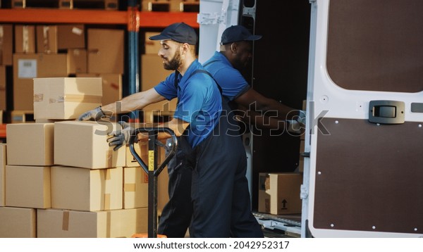 Outside of Logistics Distributions Warehouse:\
Diverse Team of Two Workers Talk, Joke Around Loading Delivery\
Truck with Cardboard Boxes, Online Orders, Medicine, Food Supply,\
E-Commerce Goods