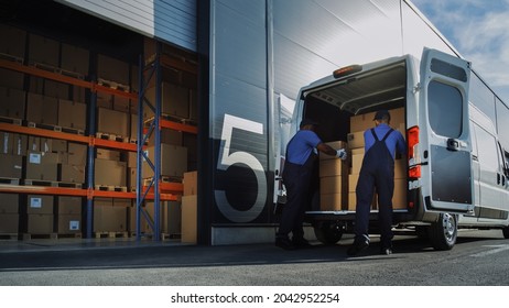 Outside of Logistics Distributions Warehouse: Two Workers Load Delivery Truck with Cardboard Boxes. Online Orders, Purchases, E-Commerce Goods.