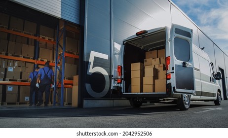 Outside of Logistics Distributions Warehouse: Two Workers Load Delivery Truck with Cardboard Boxes, Drive Off to Deliver Online Orders, Purchases, E-Commerce Goods. - Shutterstock ID 2042952506