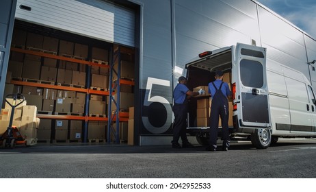 Outside of Logistics Distributions Warehouse: Two Workers Load Delivery Truck with Cardboard Boxes. Online Orders, Purchases, E-Commerce Goods.
