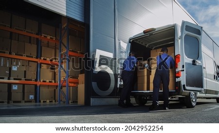 Outside of Logistics Distributions Warehouse: Two Workers Load Delivery Truck with Cardboard Boxes. Online Orders, Purchases, E-Commerce Goods.