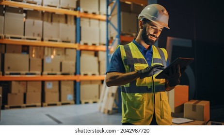 Outside of Logistics Retail Warehouse: Handsome Latin Manager Using Tablet Computer for Inventory. Delivery Service with Cardboard Boxes, Online Orders, E-Commerce. Evening Shot - Shutterstock ID 2042987720