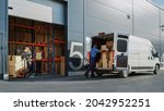 Outside of Logistics Retailer Warehouse With Manager Using Tablet Computer, Diverse Workers Loading Delivery Truck with Cardboard Boxes. Online Orders, Purchases, E-Commerce Goods.