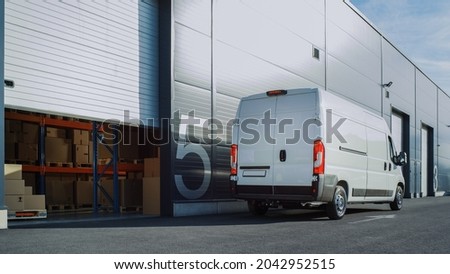 Outside of Logistics Retailer Warehouse With Manager Using Tablet Computer, Workers Start Loading Delivery Truck with Cardboard Boxes. Online Orders, Purchases, E-Commerce Goods. High Angle Shot
