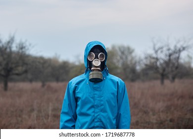 Outside Picture Of Stalker Wearing Blue Jacket And Gas Mask, Spending Time Alone, Being At 30 Km Exclusion Zone, Doing Illegal Things, Looking Directly At Camera. People And Adrenaline Concept.