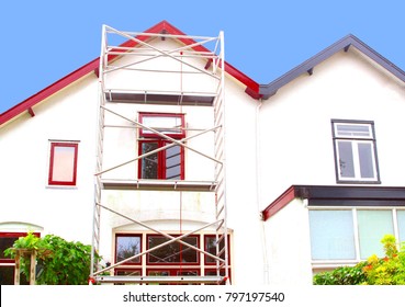 Outside residential house renovation, painting exterior walls and window frames, before and after, and scaffold tower 