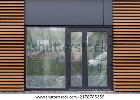 Outside solid glass door with building exterior
