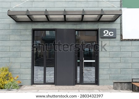 Outside solid glass door with building exterior
