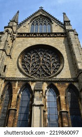Outside  and south side of the Bishop's eye window of Lincoln cathedral .round shape of window and Curvillinear  tracery is a form of tracery where the patterns are continuous curves - Shutterstock ID 2219860097