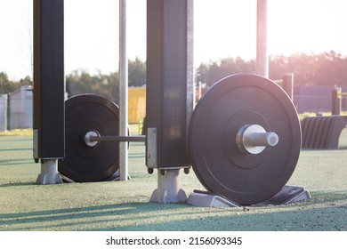 Outside Sport, Workout Gear - Heavy Weights On Green Artificial Grass Surface On A Sunny Day. 