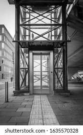 Outside Steel And Glass Elevator In Black And White