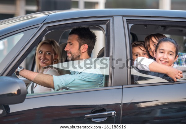 Outside\
view of a beautiful family driving in\
automobile