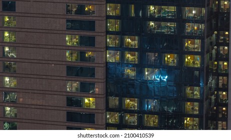 Outside View Of Panoramic Windows In Apartments Of A High Class Building At Night Timelapse. Glowing Lights In Skyscraper