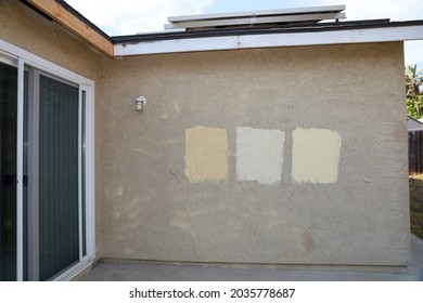 The Outside Wall Of House Painted With Three Different Paint Samples.