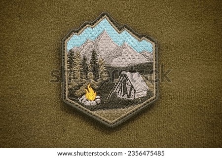 The outsider camp morale patch is a velcro patch used for attaching to clothing and bags.