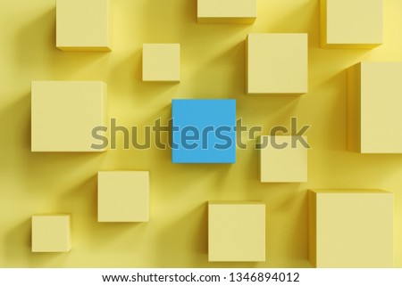 outstanding blue box among yellow boxes on yellow background. minimal flat lay contept