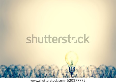 Outstanding creative idea background concept . one Light bulb glowing among a group light bulbs.vintage color tone