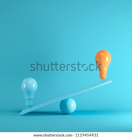 Outstanding Orange light bulb floating on blue seesaw on blue background, minimal idea concept.