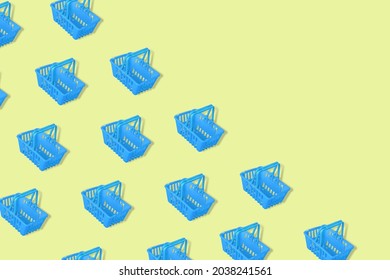 Outstanding Pattern With Blue Empty Shopping Baskets Isolated On A Yellow Background. Modern Minimal Design Art For Poster, Branding, Banner, Shopping Bag, And Cards. Copy Space.