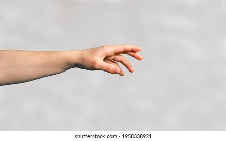 Outstretched arm and hand with fingers showing into a direction. 
