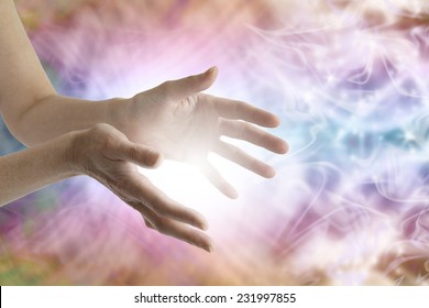 Outstretched Female Healing Hands With White Light Between And Vibrant Energy Field In Background 