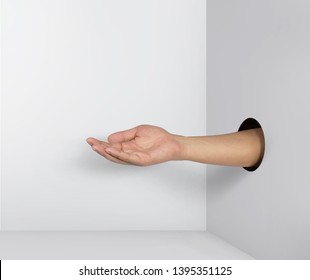 Outstretched hand gesture, holding, asking or offering something, coming out from a hole of paper. 