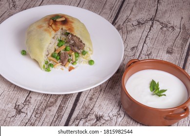 Ouzi Or Ozi Is Dough Flakes Stuffed Rice And Meat. And Yogurt Bowl  Syrian Food 