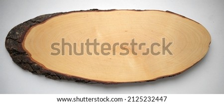An oval cut of a tree on a white isolate, a clean place for the inscription.Age-old rings on a tree. Woodworking.