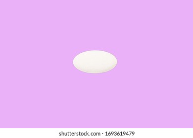 Oval Medical Pill Isolated On A Pink Background. Flat Lay. Copy Space. Medical Pill Concept.