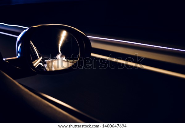 Oval mirror car reflecting highway driving inside
a tunnel