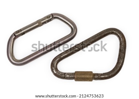 Oval titanium non-locking​ carabiner with sprung solid gate and vintage steel locking triangular shape carabiner with straight screw gate on a white background, top view 