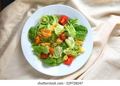 Ovehead View Of Salad With Cherry Tomatoes And Cornbread