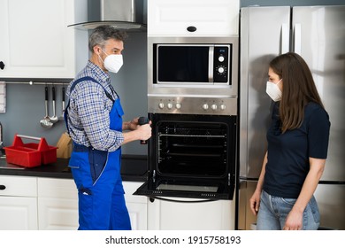 Oven Appliance Appliance In Kitchen By Handyman In Face Mask