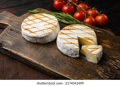 Oven Backed camembert, on old dark  wooden table background