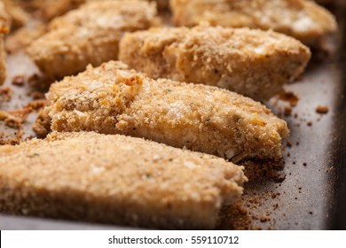 Oven Baked Parmesan Crusted Chicken Tenders On A Seasoned Baking Stone