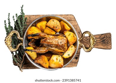 Oven baked quail with potatoes, spices and herbs in a skillet. Isolated, white background