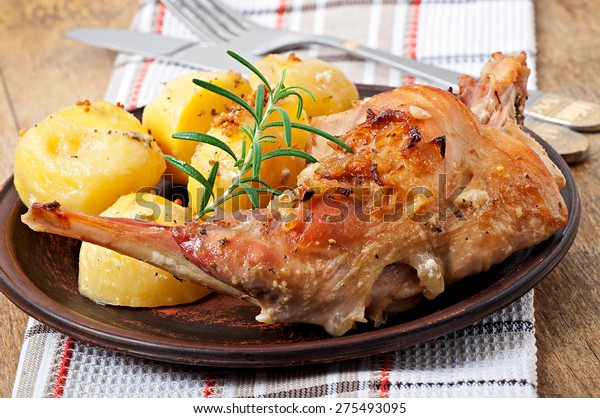 Oven Baked\
rabbit legs with potatoes and\
rosemary