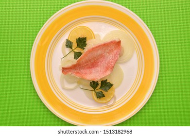 Oven Baked Redfish Parsley Onions Lemons Plate On Green Table Cloth