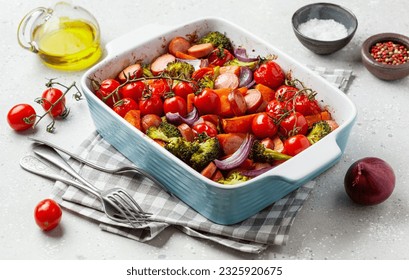 oven baked vegetables and sausages, healthy lunch, sweet potato onion tomato broccoli - Powered by Shutterstock