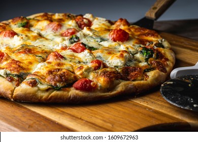 Oven Baked Vegetarian Pizza On Wooden Pizza Peel