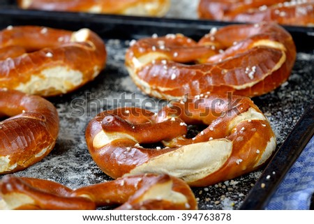 Oven fresh handmade crispy Bavarian pretzels on baking sheets