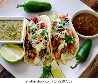 Oven Fried Cod Fish Tacos, With Cabbage Tomatoes, Roasted Corn, Avocado-cilantro Sauce And Salsa