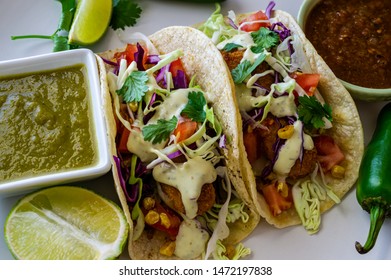 Oven Fried Cod Fish Tacos, With Cabbage Tomatoes, Roasted Corn, Avocado-cilantro Sauce And Salsa