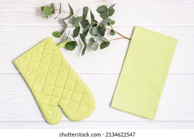 Oven Mitt Potholder And Tea Towel On White Wooden Background. Kitchen Accessory. Cooking Mitten, Oven-glove. Flat Lay.