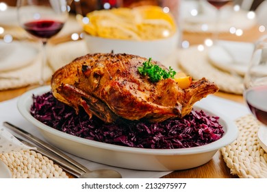 Oven roasted duck - whole baked duck with red cabbage and potato pancakes