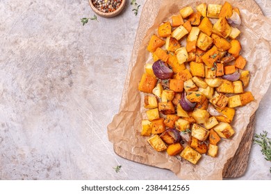 Oven-baked vegetables on a baking sheet. Baked pumpkin, potatoes, carrots and onions. Cooking dinner in the oven. Vegetarian food in the oven. Vegan cuisine. Proper and healthy nutrition - Powered by Shutterstock