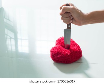 Over light and Solid shadow image of knife Stabbed red heart on blur image background. for broken heart concept or accompanying articles about philosophy.