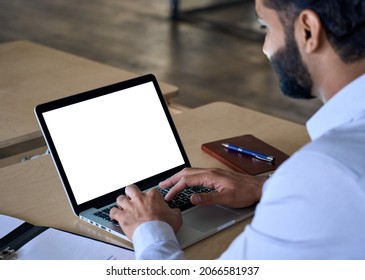 Over shoulder closeup view of male indian businessman looking at empty blank mockup screen for advertising, working, typing, planning, analyzing data. Business technologies concept. - Powered by Shutterstock